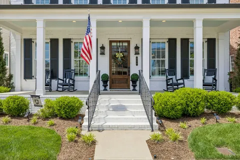 a front view of a building with outdoor seating