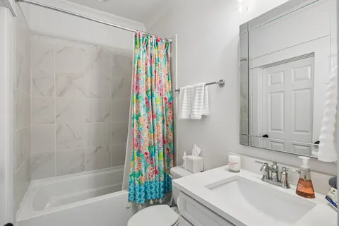 a bathroom with a shower curtain and a sink