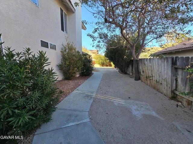 a view of a house with backyard and porch