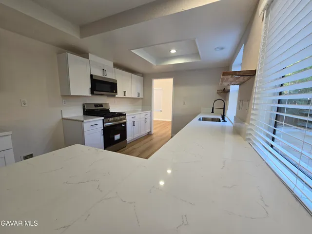 a kitchen with counter top space and stainless steel appliances