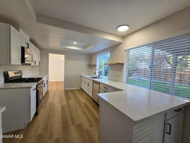 a view of kitchen and wooden floor