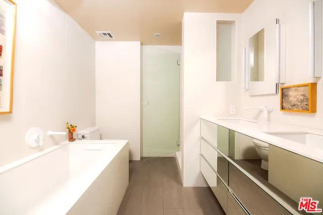 a bathroom with a double vanity sink and a bathtub