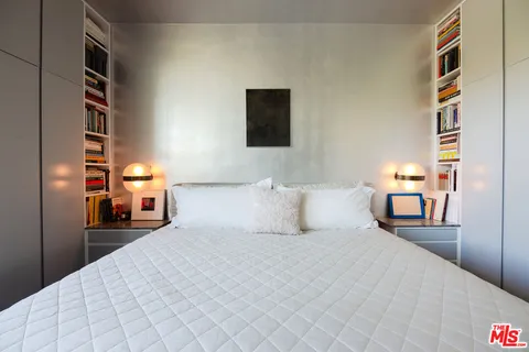 a bed room with a bed and a night stand