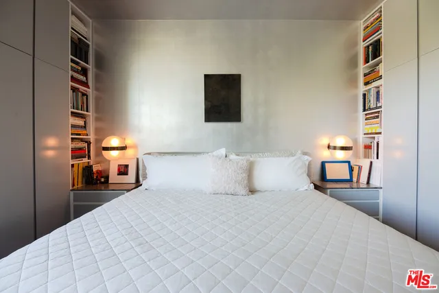 a bed room with a bed and a night stand