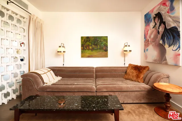 a living room with furniture and a painting