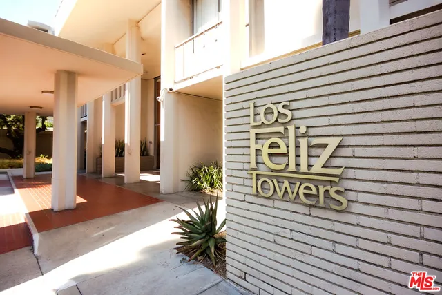 a view of a street with potted plants