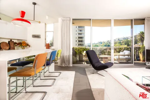 a living room with furniture and a floor to ceiling window