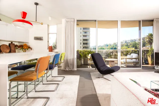 a living room with furniture and a floor to ceiling window