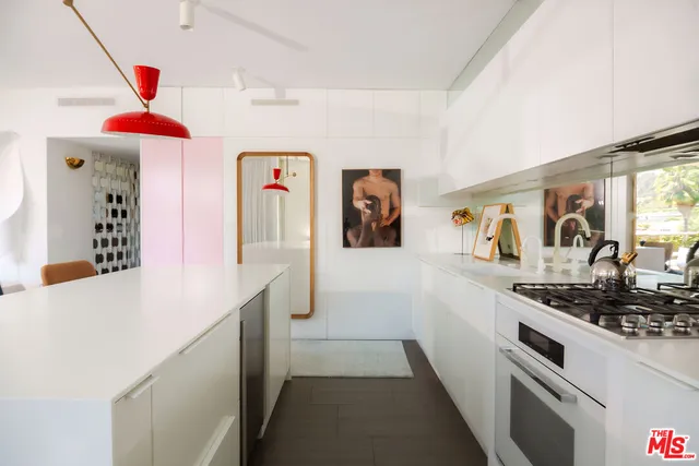 a hallway with a white stove top oven and refrigerator
