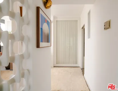 a view of a hallway to rooms