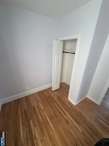 a view of a room with wooden floors and stairs