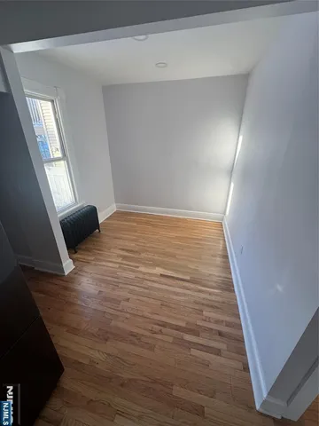 a view of an empty room and wooden floor