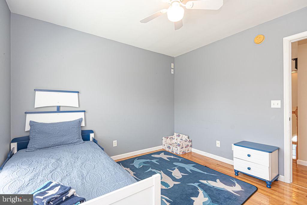 10671 Cathell Road Berlin, MD 21811 - Photo 39 of 63 a bedroom with a bed and wooden floor
