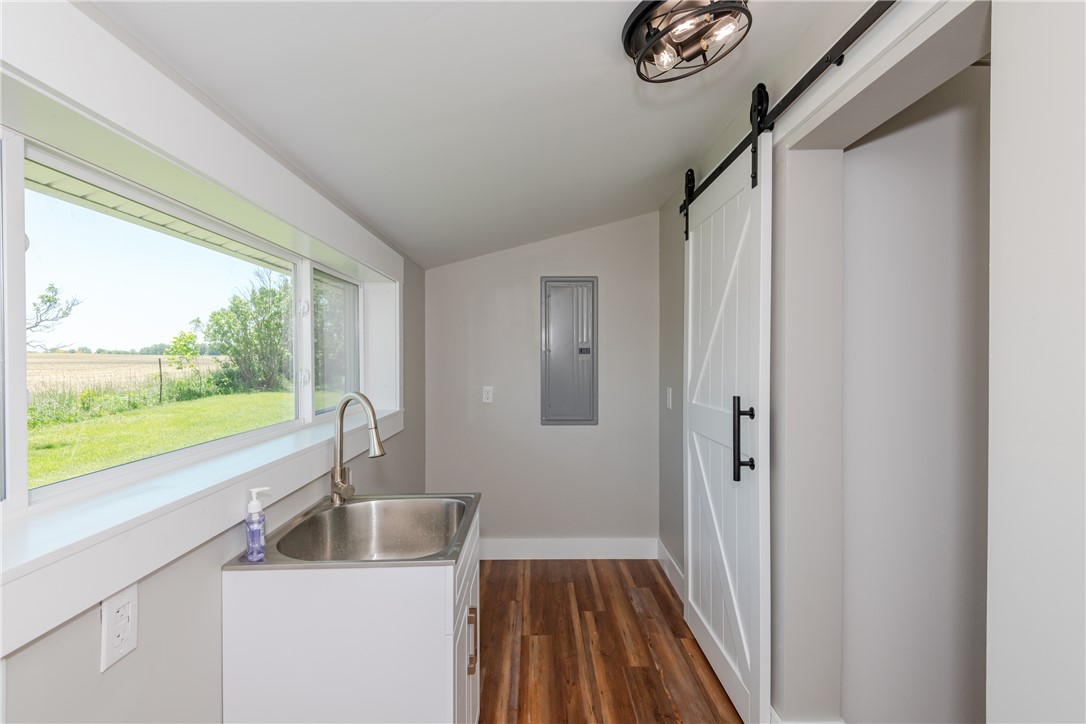 1217 Jasper Road Xenia, OH 45385 - Photo 47 of 62 This bright laundry space features a utility sink, large window, and modern barn door.