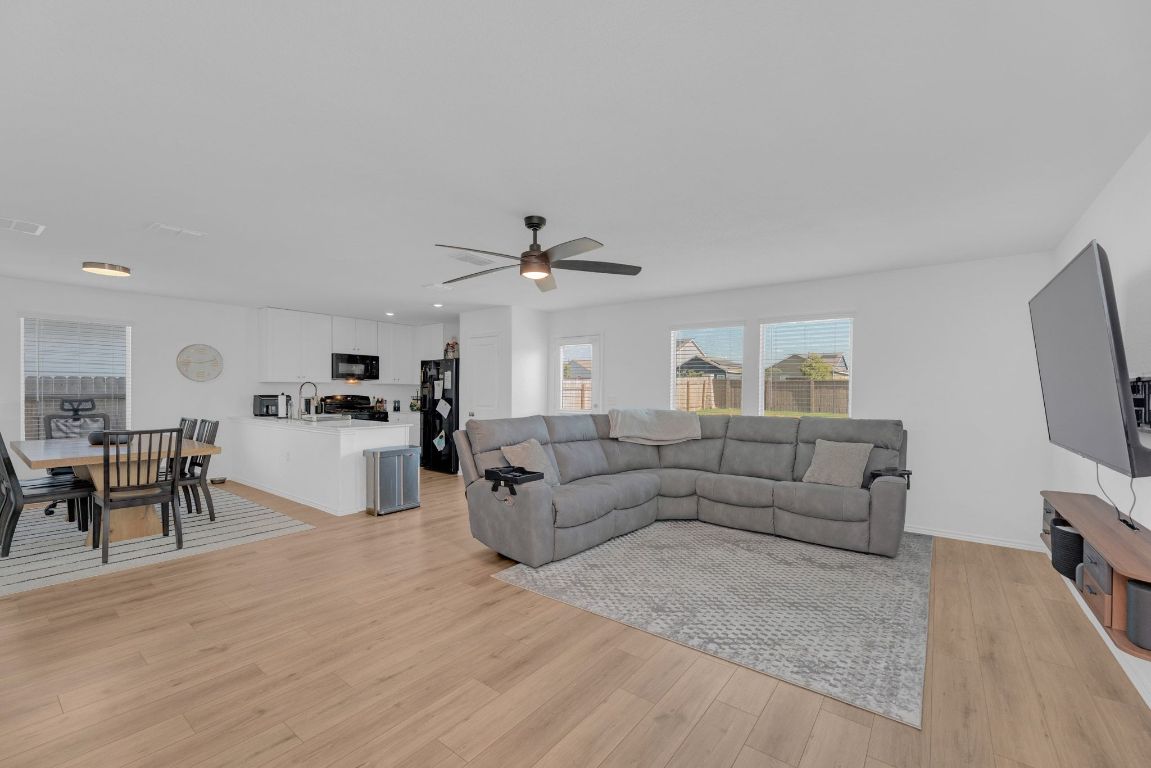 2324 Willkomen Way Pflugerville, TX 78660 - Photo 21 of 21 a living room with furniture and a flat screen tv