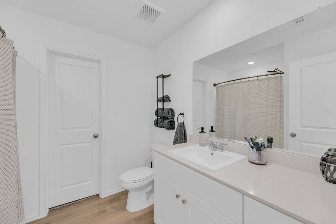 2324 Willkomen Way Pflugerville, TX 78660 - Photo 12 of 21 a bathroom with a sink toilet and shower