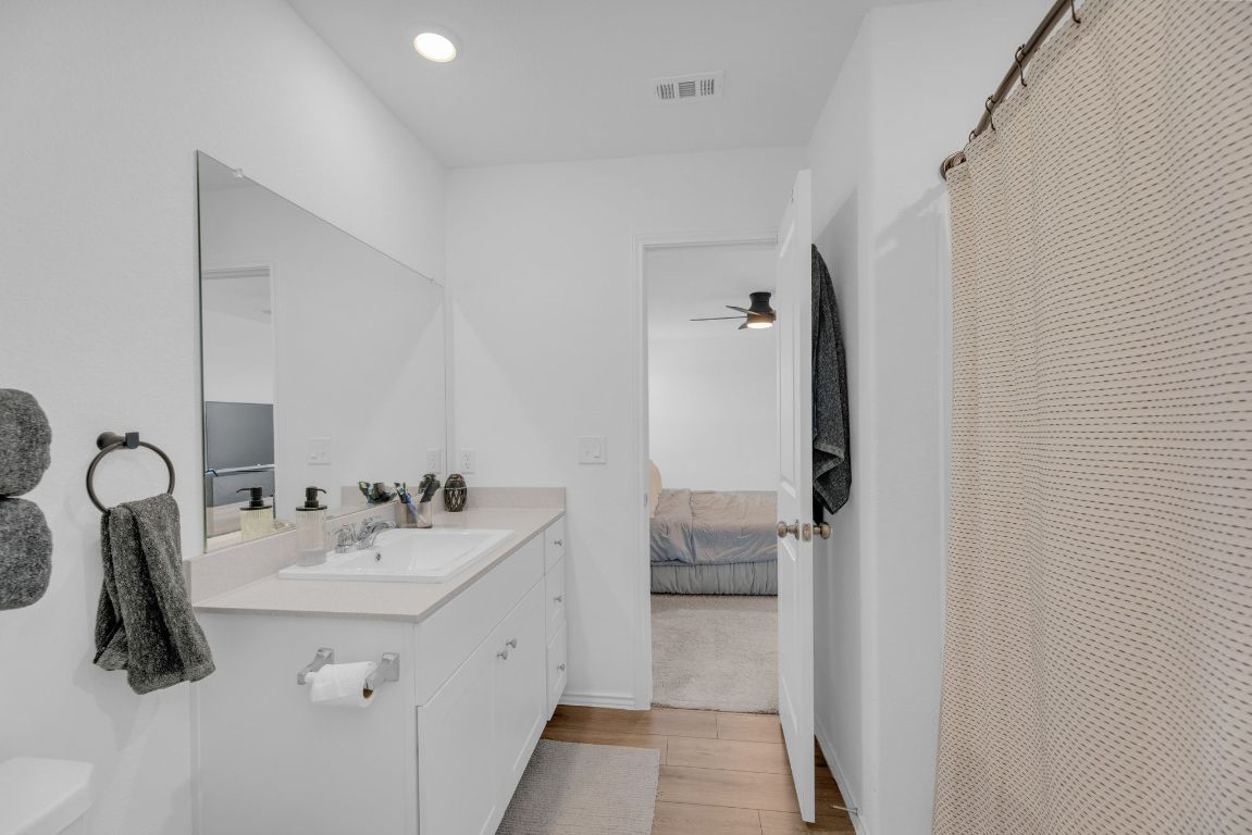 2324 Willkomen Way Pflugerville, TX 78660 - Photo 13 of 21 a en suite bathroom with a sink and mirror