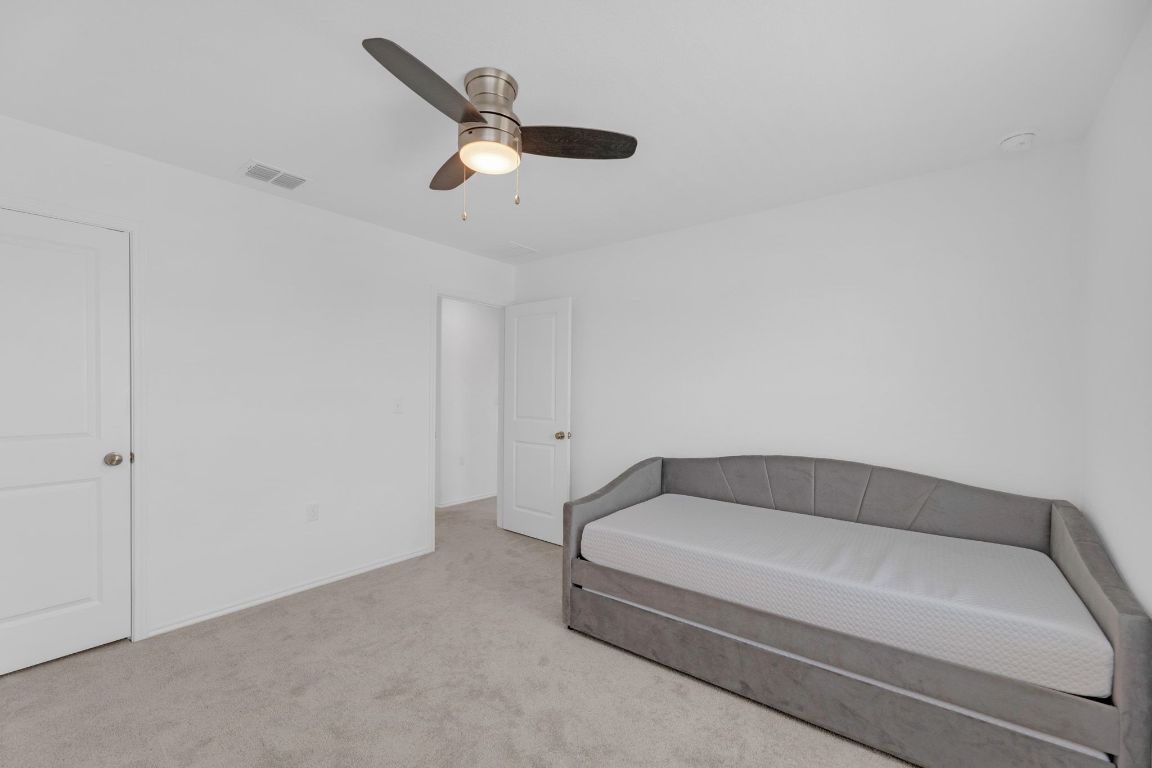 2324 Willkomen Way Pflugerville, TX 78660 - Photo 16 of 21 a spacious bathroom with a bathtub and ceiling fan