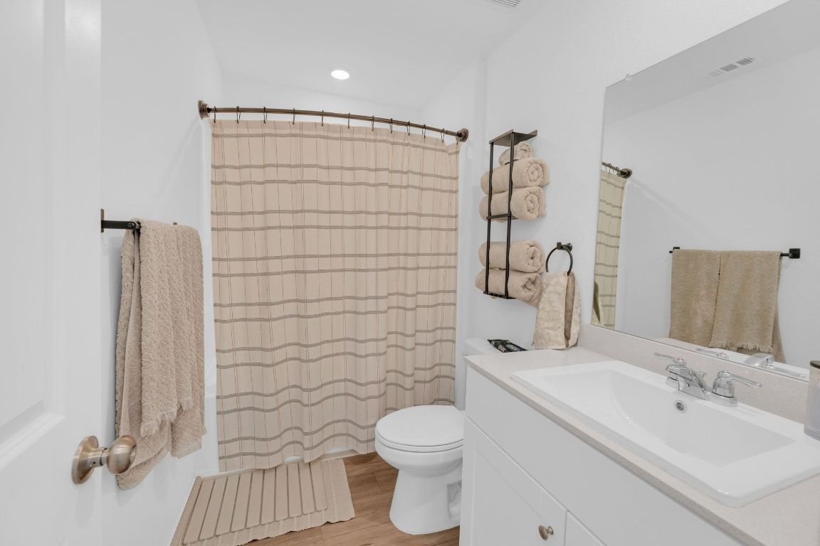 2324 Willkomen Way Pflugerville, TX 78660 - Photo 17 of 21 a bathroom with a sink toilet and shower