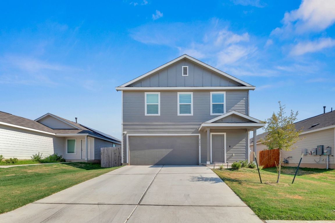 2324 Willkomen Way Pflugerville, TX 78660 - Photo 2 of 21 a front view of a house with a yard