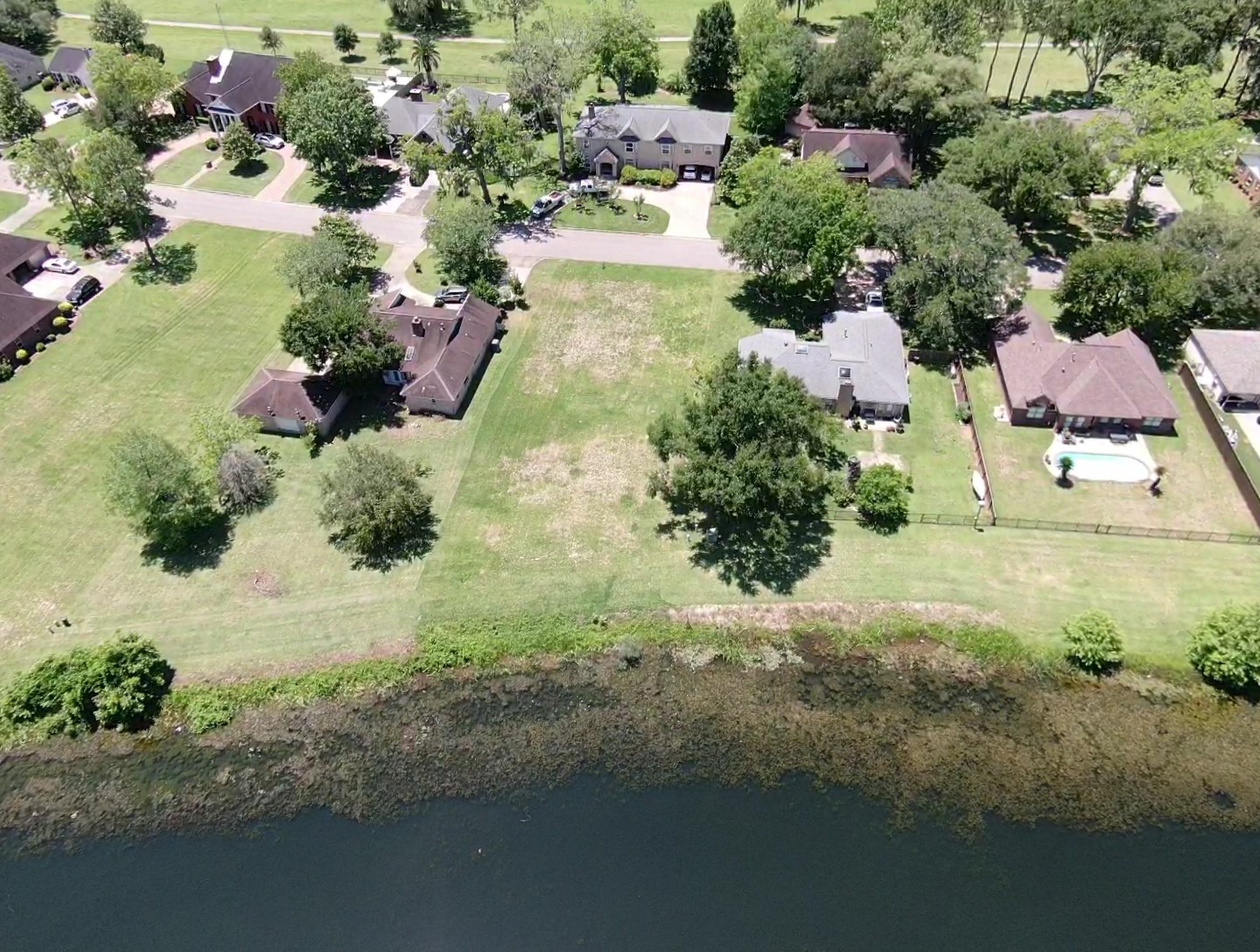 2209 Riverside Drive West Columbia, TX 77486 - Photo 4 of 9 a view of a lake with huge green field