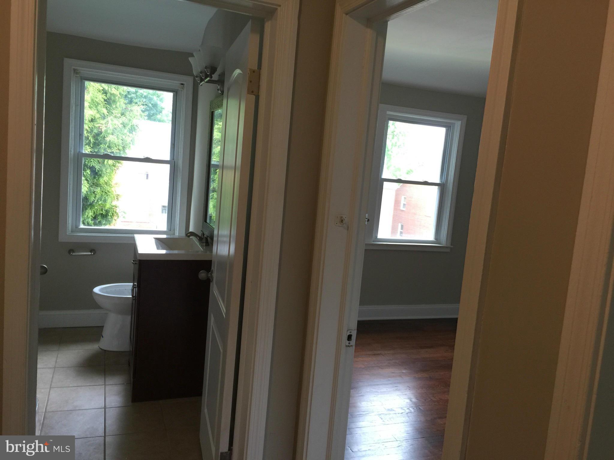 1021 Upnor Road Baltimore, MD 21212 - Photo 12 of 24 a view of an empty room with wooden floor and a window