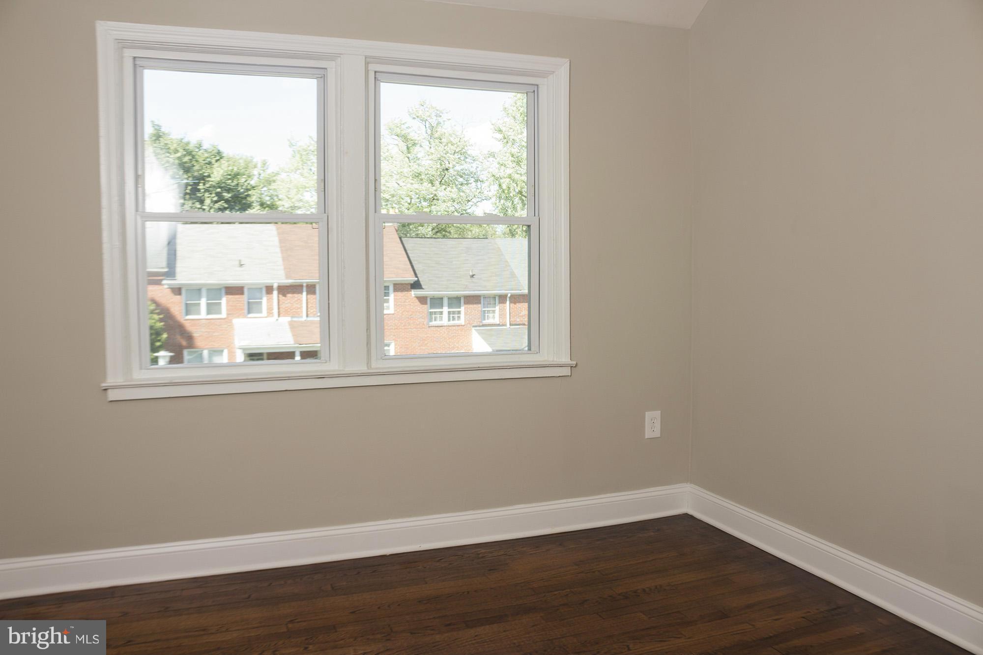 1021 Upnor Road Baltimore, MD 21212 - Photo 16 of 24 a view of a small space with wooden floor and a window