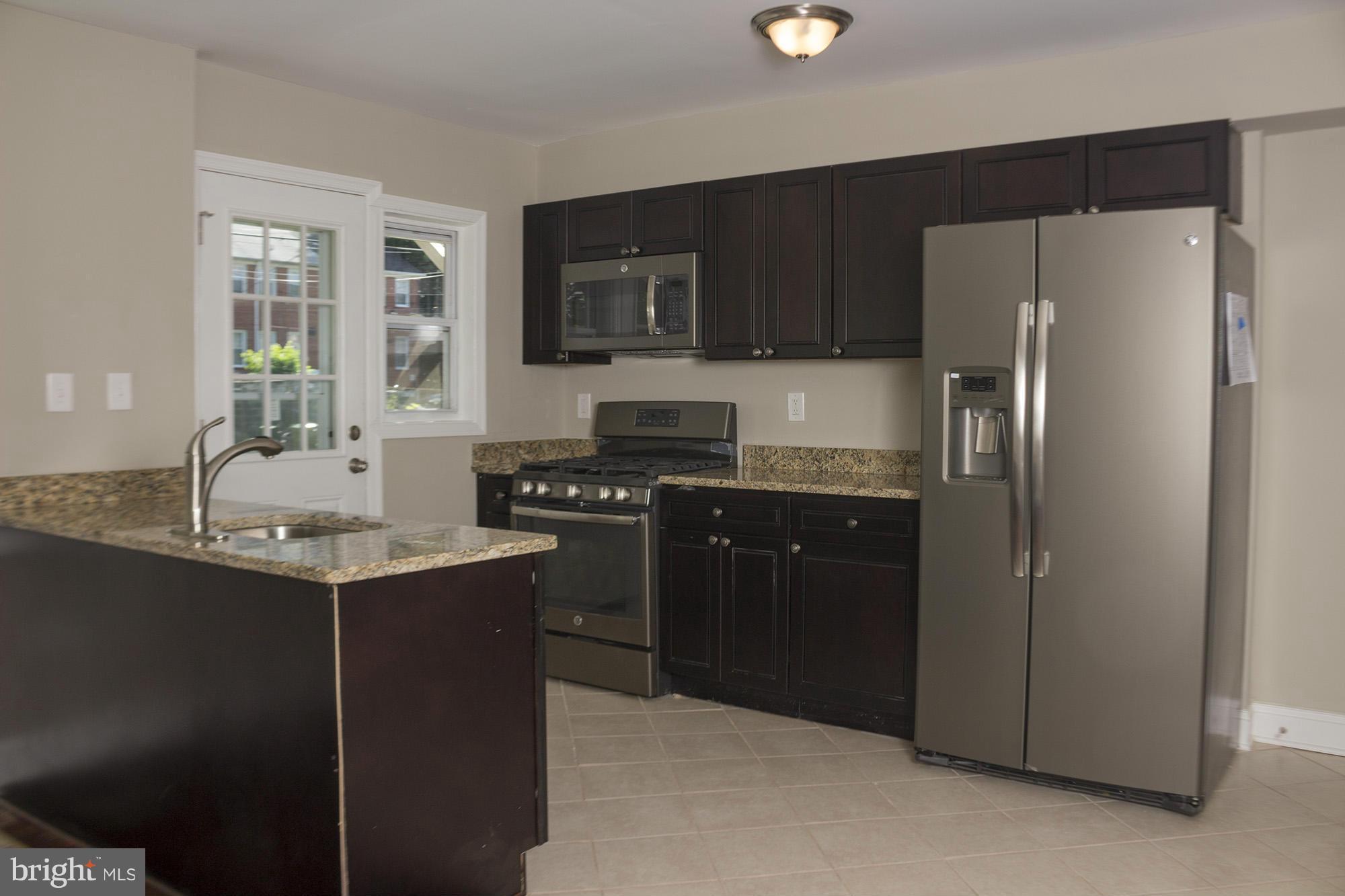 1021 Upnor Road Baltimore, MD 21212 - Photo 5 of 24 a kitchen with stainless steel appliances granite countertop a refrigerator stove and sink