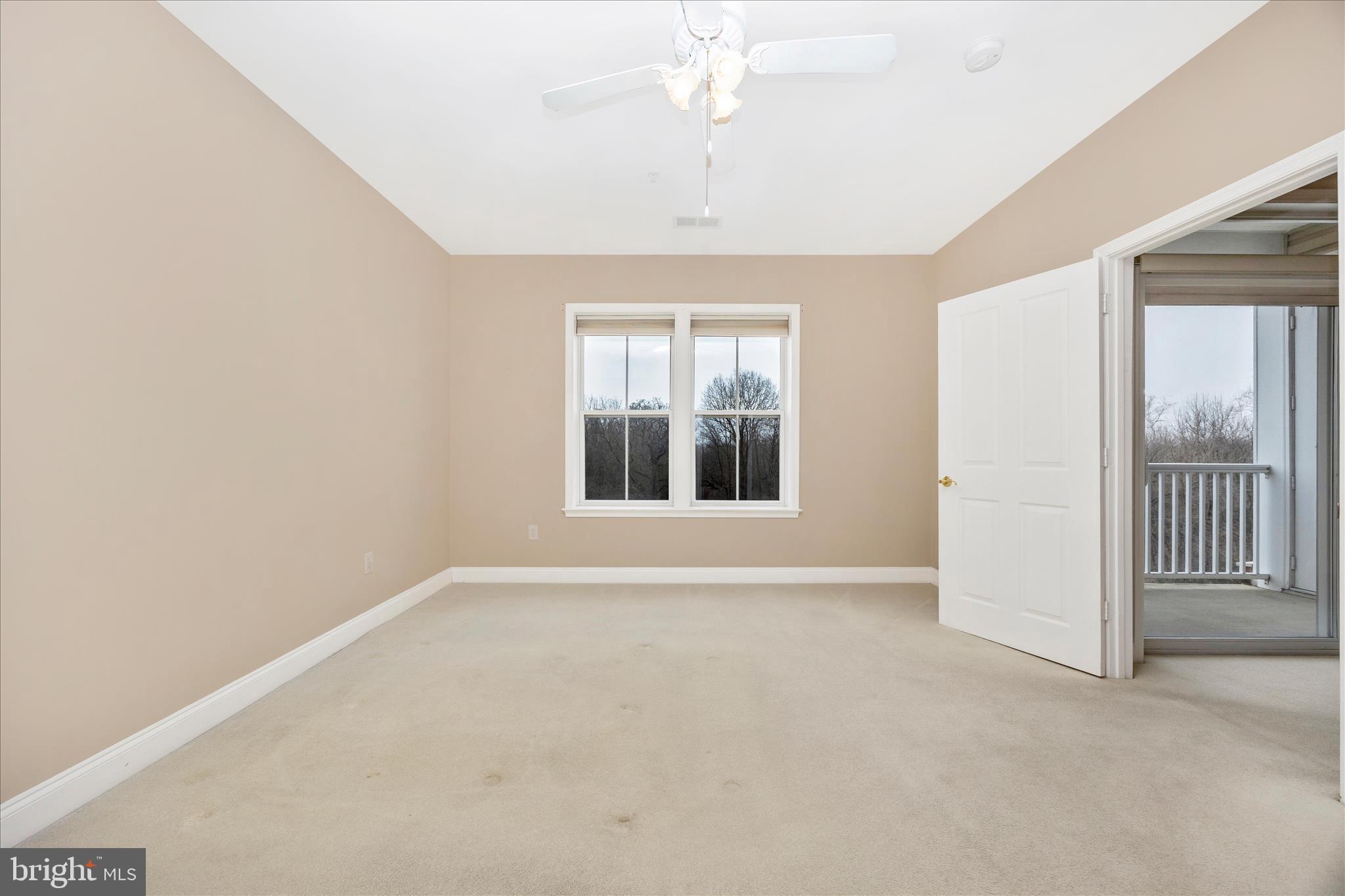 2250 Bear Den Road, Unit 207 Frederick, MD 21701 - Photo 16 of 43 an empty room with windows and chandelier fan