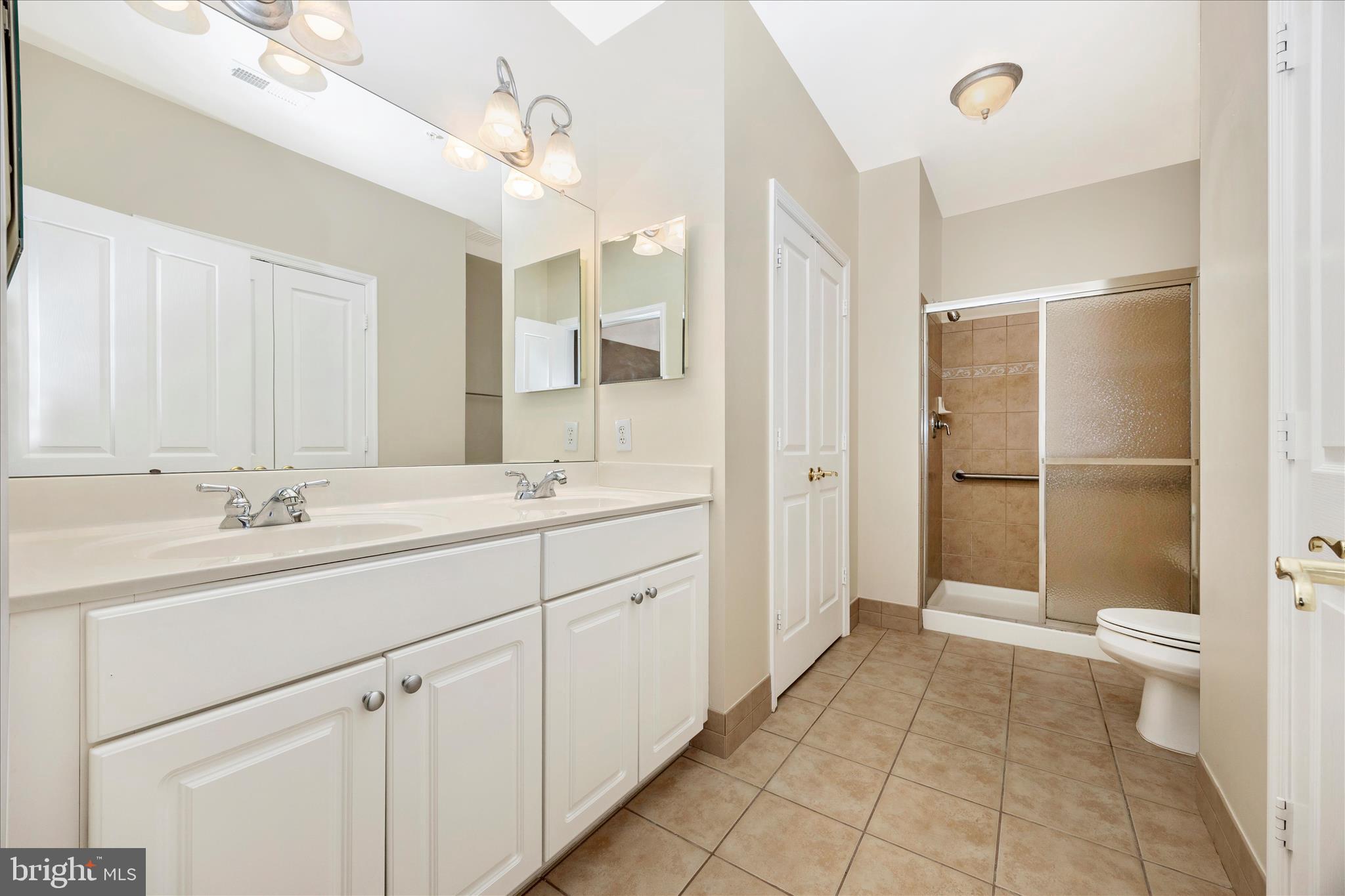 2250 Bear Den Road, Unit 207 Frederick, MD 21701 - Photo 18 of 43 a bathroom with a sink a toilet and shower