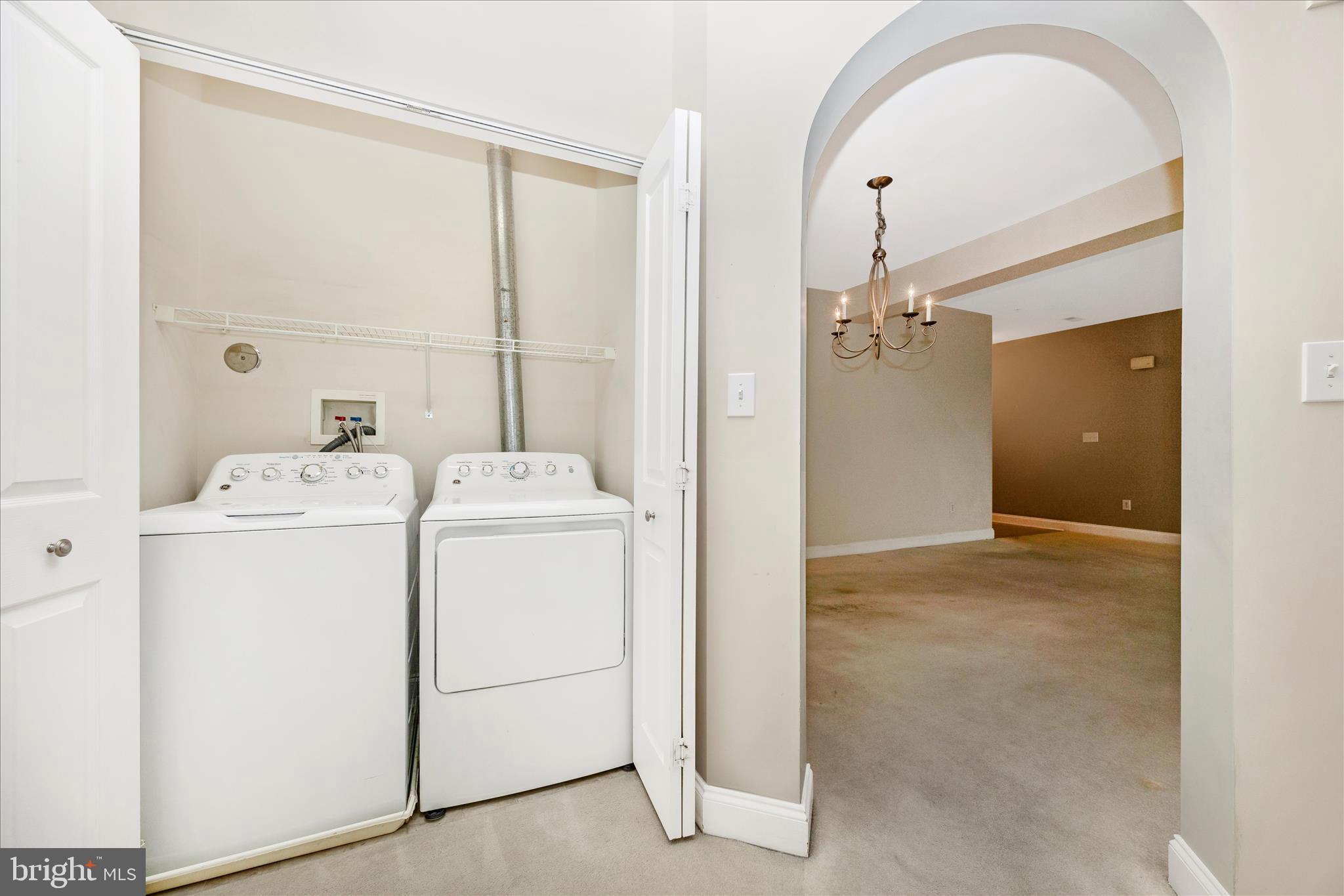 2250 Bear Den Road, Unit 207 Frederick, MD 21701 - Photo 26 of 43 a view of a storage & utility room with dryer and washer