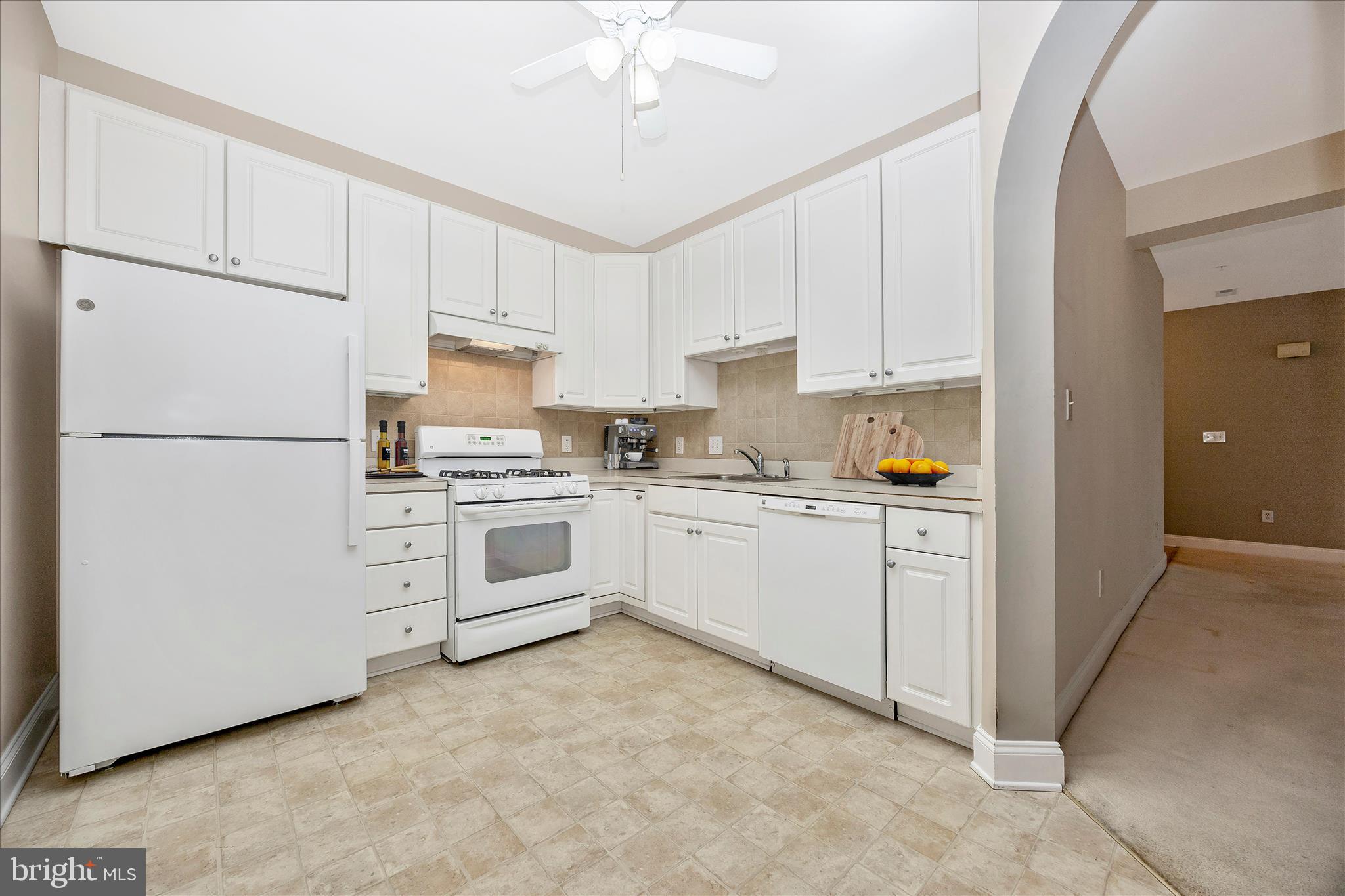 2250 Bear Den Road, Unit 207 Frederick, MD 21701 - Photo 10 of 43 a kitchen with white cabinets and white appliances