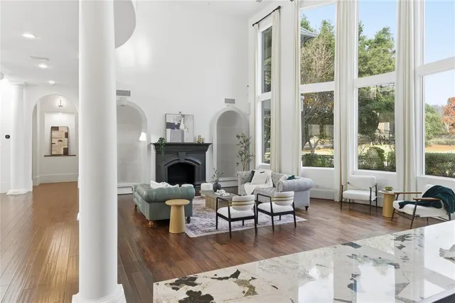 a living room with furniture a large window and a fireplace