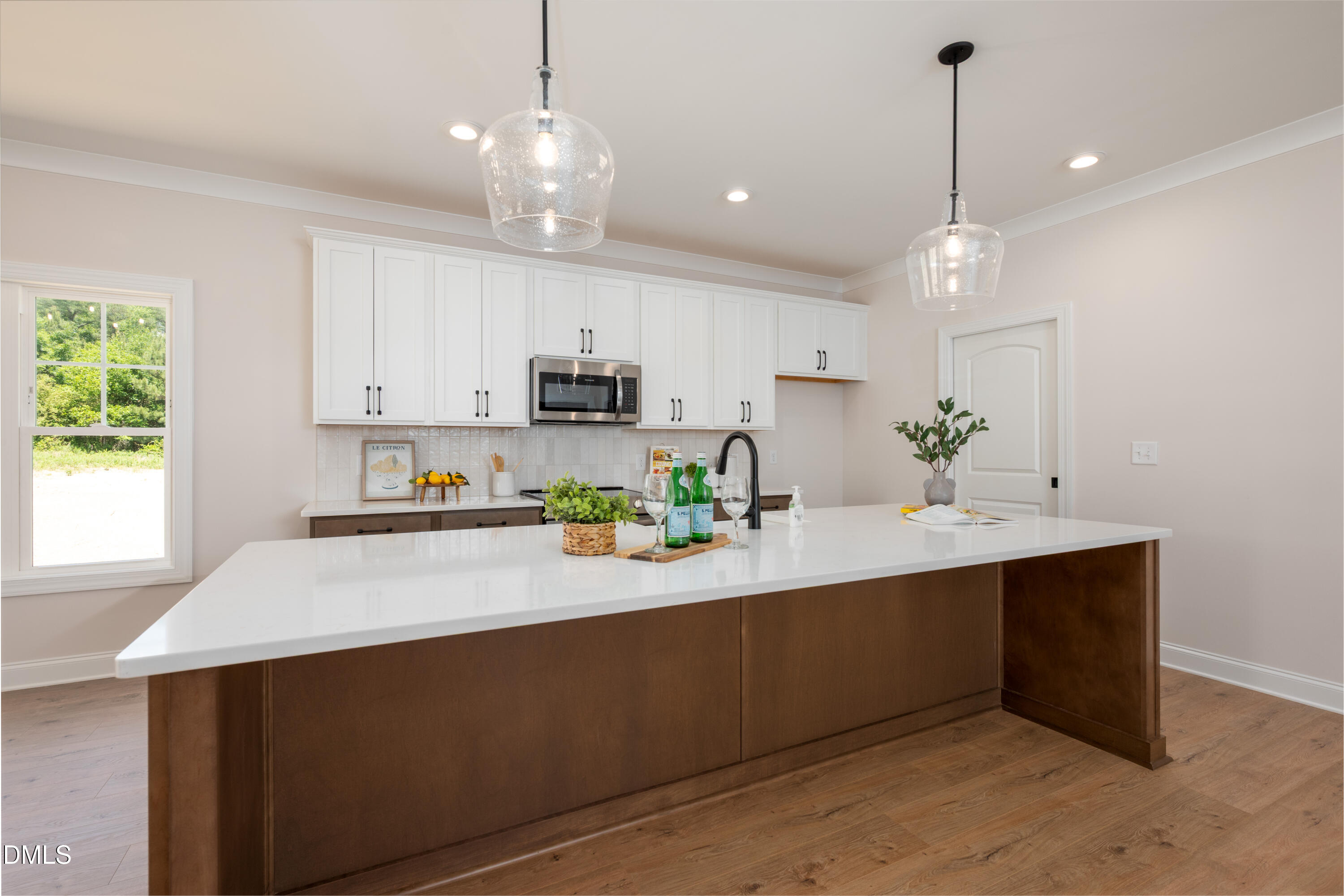 2275 Peachtree Hills Road Spring Hope, NC 27882 - Photo 13 of 43 a kitchen with kitchen island white cabinets and appliances
