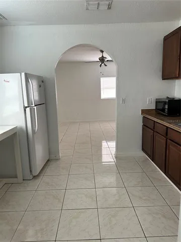 a kitchen with stainless steel appliances a counter top space and cabinets