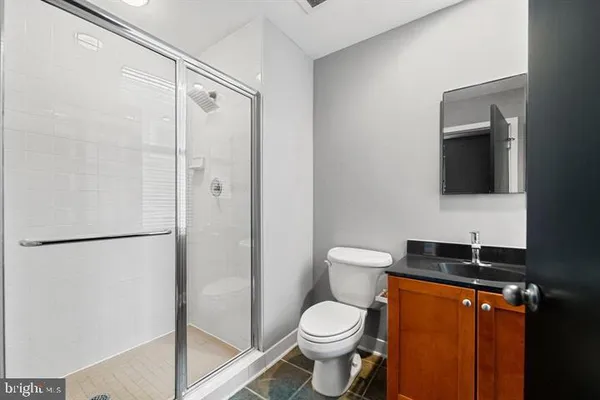 a white toilet sitting next to a bathroom sink