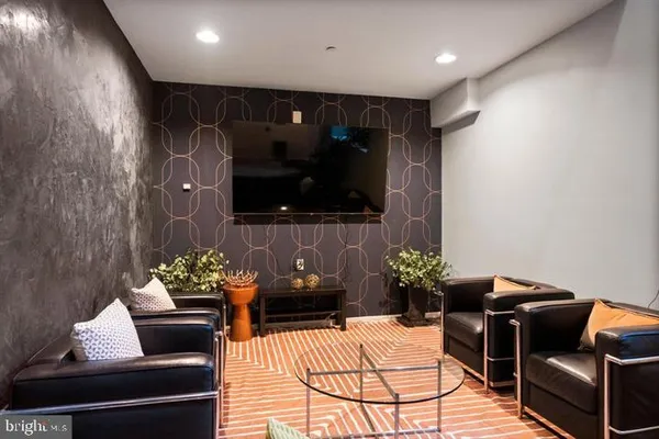 a living room with furniture flowerpot and a potted plant