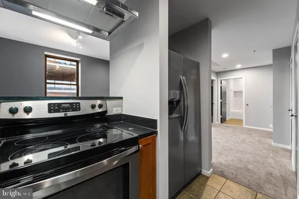 a kitchen with a stove and a refrigerator