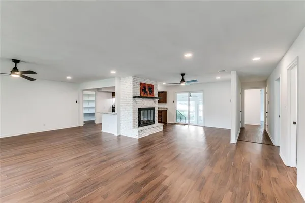 a view of a kitchen with a kitchen island wooden floor and a window