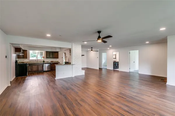 a view of a kitchen with a sink and a stove top oven
