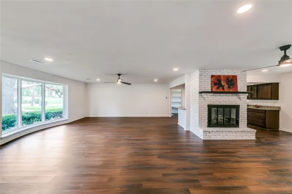 a view of a room with wooden floor and a fireplace