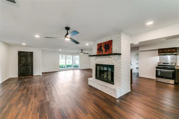 a view of a livingroom with a fireplace a fireplace and wooden floor