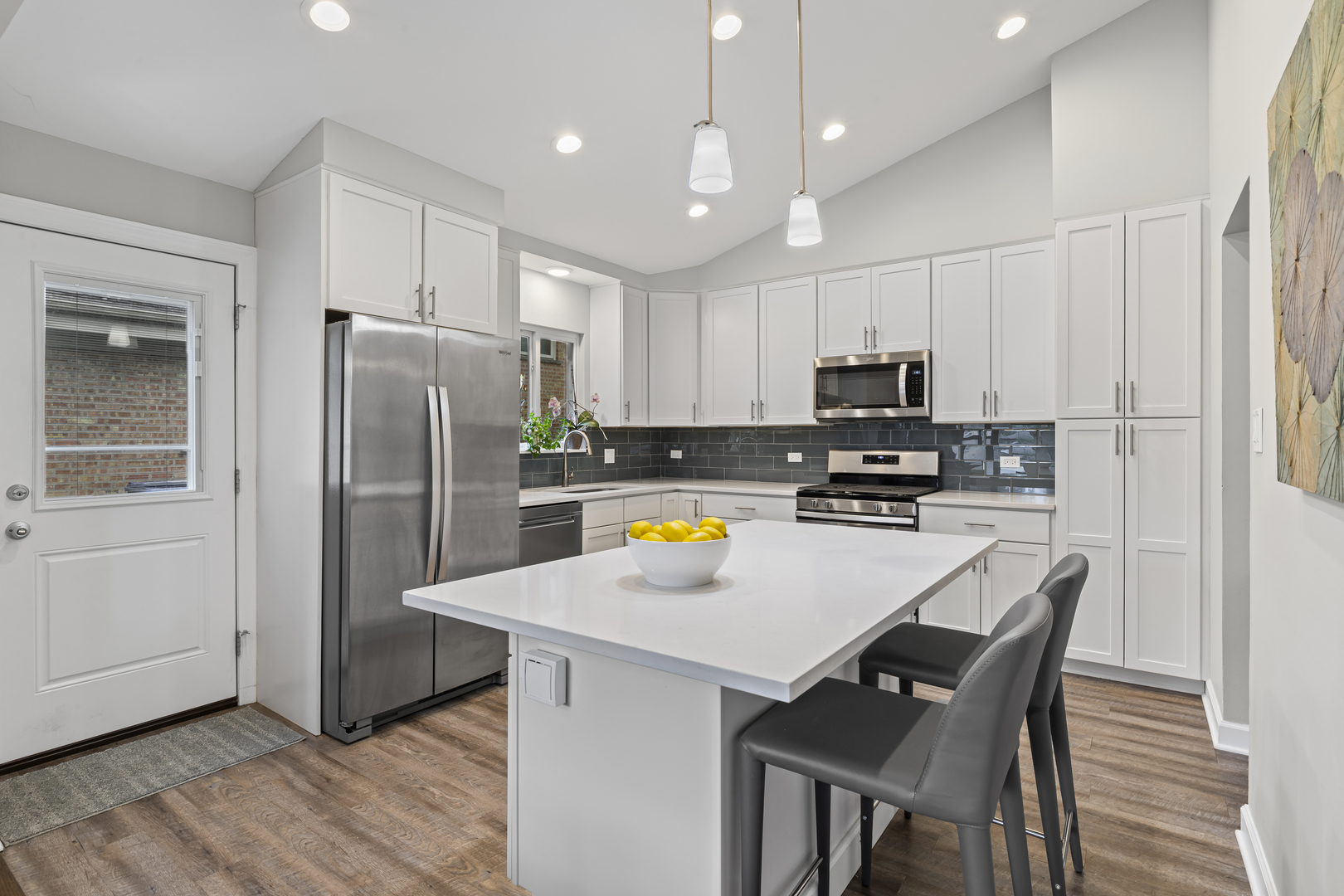 619 Leamington Avenue Wilmette, IL 60091 - Photo 6 of 19 a kitchen with stainless steel appliances a refrigerator a stove a sink a dining table and chairs