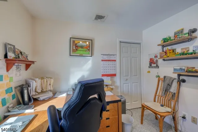 a view of staircase with lots of frames on wall and a window