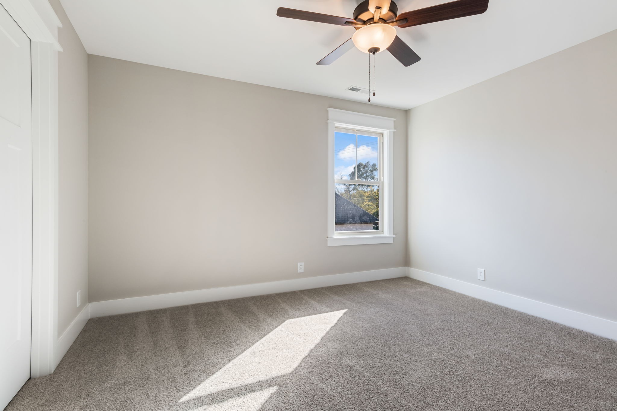 2712 Carousel Drive Murfreesboro, TN 37128 - Photo 33 of 36 an empty room with a chandelier fan and windows