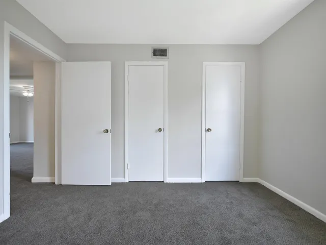 a view of an empty room and closet area