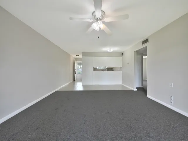 a view of a livingroom with a ceiling fan and window