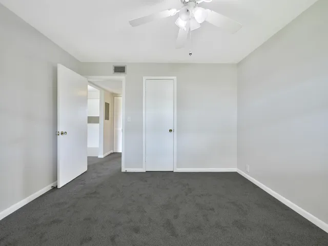 an empty room with a empty space and a ceiling fan