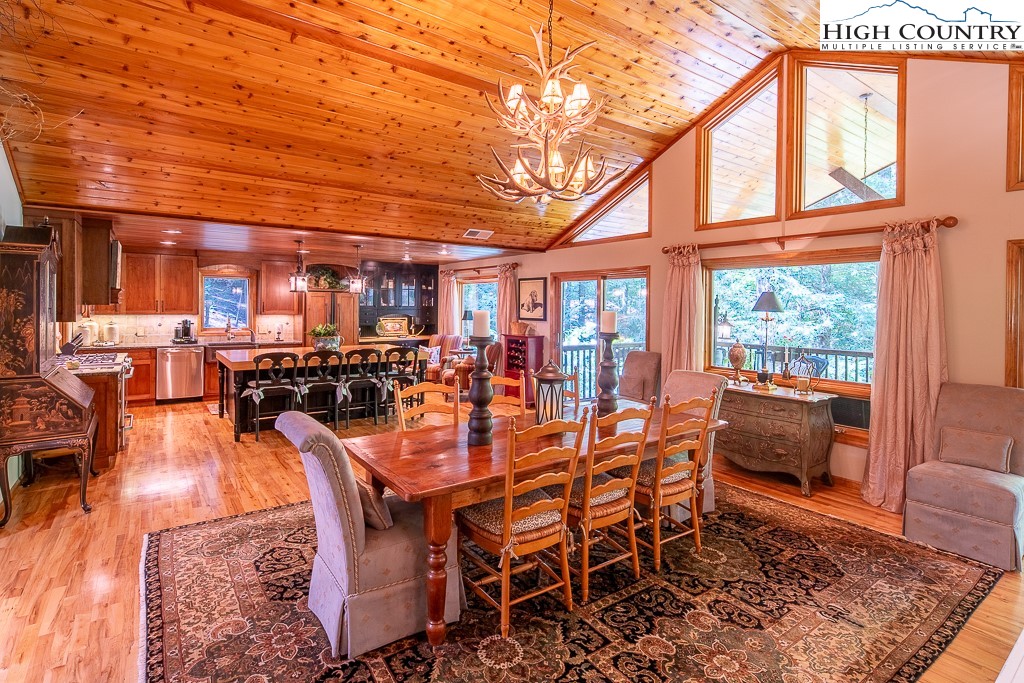 127 Apple Tree Boone, NC 28607 - Photo 11 of 50 a dining room with furniture a rug and a large window