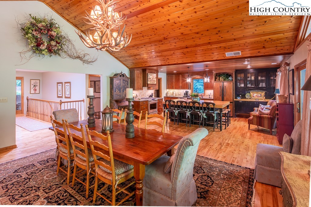 127 Apple Tree Boone, NC 28607 - Photo 12 of 50 a view of a dining room with furniture a chandelier and wooden floor